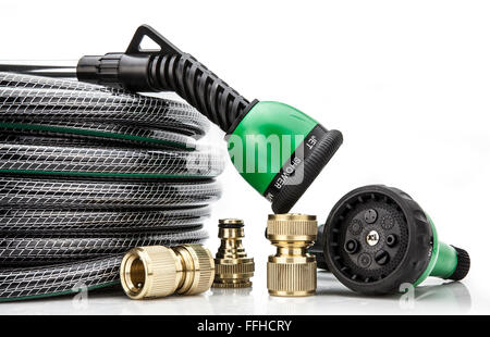 A  garden hose with a sprayer and fittings on a white background Stock Photo