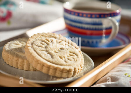 Freshly, handmade shortbread biscuits stamped with the words, I love you. Served with coffee on a tray Stock Photo