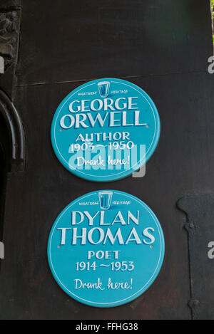 Two commemorative blue plaques for George Orwell ( aurhor) and Dylan Thomas (poet) on display outside a pub in London, UK. Stock Photo