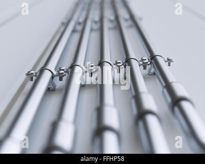 Metal pipes mounted on a wall close-up Stock Photo