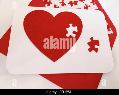 Valentine's Day Card with a heart shaped jigsaw puzzle Stock Photo