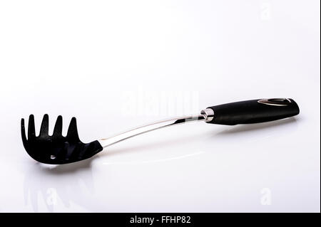 Spaghetti or pasta scoop.Kitchen equipment untensil. Stock Photo