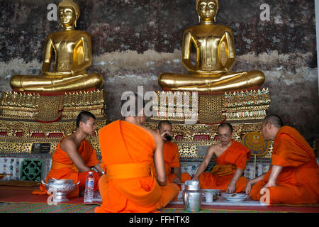 Monks praying in Wat Suthat Thepwararam Temple. Bangkok. Monks at Wat Suthat Thepwararam Ratchaworamahaviharn, Bangkok, Thailand Stock Photo