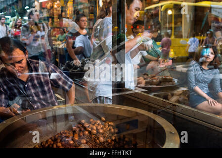 Roast chestnuts , Bangkok's Chinatown , Thailand. Market stall and street food being prepared in Chinatown Bangkok, Thailand. Ya Stock Photo