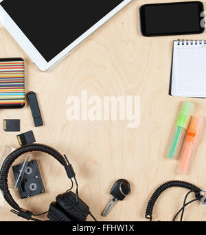 Flat lay office tools and supplies, tablet computer,audio headphone cards and other stuff. Flat design and top view on desk as f Stock Photo
