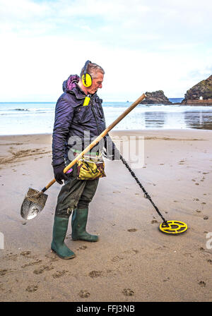 Man using a metal detector on portreath beach in cornwall, uk Stock Photo