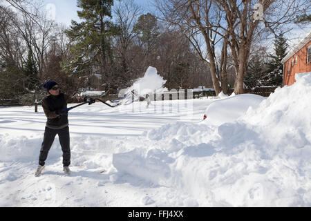 Man shoveling snow from driveway - Virginia USA Stock Photo