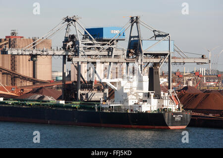 freighter SC Lotta Monrovia loading crude ore in the industrial harbour at Rotterdam, Netherlands Stock Photo