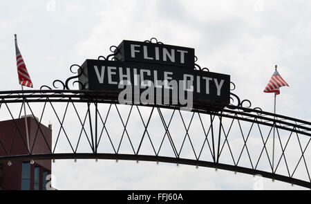 FLINT, MI - AUGUST 22: Flint Vehicle City sign, shown here on August 22, 2015, spans downtown Flint, MI. Stock Photo