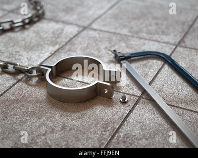 Breaking chains by hacksaw concept Stock Photo