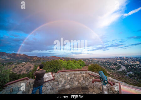 Rainbow over Hollywood Sign and Los Angeles. Scenic view from Hollywood Bowl Overlook. With rainbow and rain storm clouds. Stock Photo