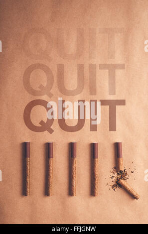 Quit smoking concept, flat lay arranged cigarettes with broken one at the end as final decision to quit is made Stock Photo
