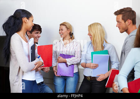 Happy students talking in the university hall Stock Photo