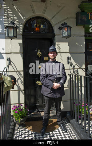 A man in costume (old Police uniform) outside the famous Sherlock Holmes Museum in Baker Street, London, United Kingdom. Stock Photo