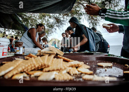 Volunteers from different Europeean NGO's offer food and hot tea to the refugees arriving by floating boat in the northern part Stock Photo