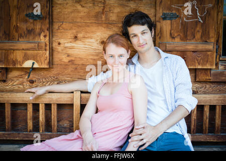 Portrait of happy couple sitting side by side Stock Photo