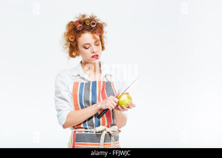 Housewife cutting apple isolated on a white background Stock Photo