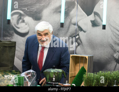 Actor Mario Adorf poses in front of a wall with a giant photo of actors Marcello Mastroianni and Anita Ekberg at the joint Italian stand of the Ambiente consumer goods fair in Frankfurt/Main, Germany, 15 February 2016. Italy is this year's host country. Photo: Arne Dedert/dpa Stock Photo
