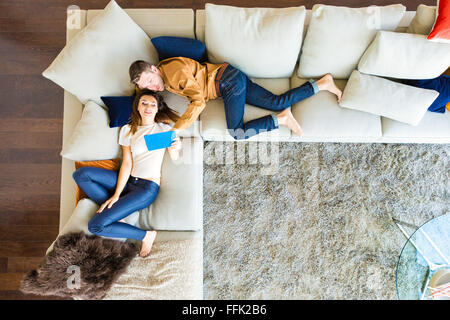 Couple relaxing in modern apartment Stock Photo