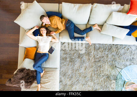 Couple relaxing in modern apartment Stock Photo