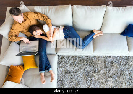 Couple relaxing in modern apartment Stock Photo