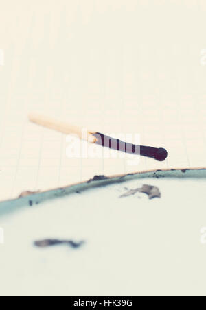 burned match and paper Stock Photo