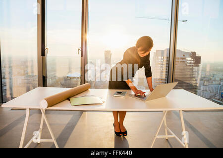 Female architect in office working on laptop Stock Photo