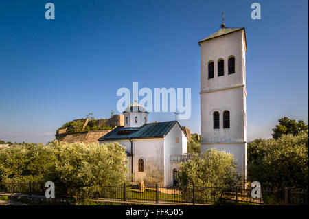 Small white church and bell tower in Ulcinj town, Montenegro Stock Photo