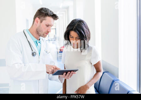 Doctor with nurse using digital tablet Stock Photo