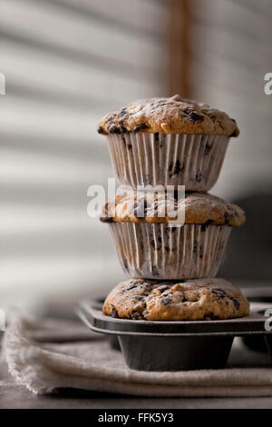 Stack of freshly baked banana chocolate chip muffins Stock Photo
