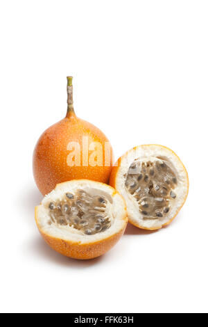 Whole and partial orange passion fruit on white background Stock Photo