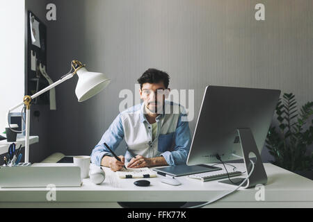 Young graphic designer working in office Stock Photo