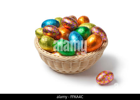 Chocolate Easter eggs in colored foil in a basket Stock Photo