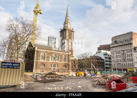 Omnipresent construction in the City of London as new developments spring up in front of St Botolph Without Aldgate Stock Photo