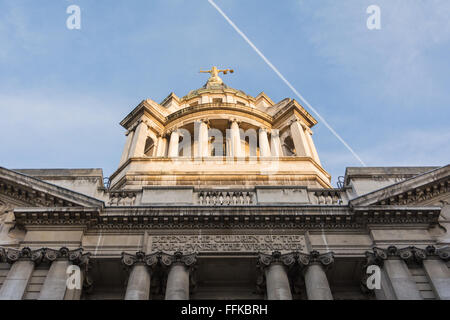 The statue of Lady Justice or the Scales of Justice above the Central Criminal Court, Old Bailey, with a jet passing overhead. Stock Photo