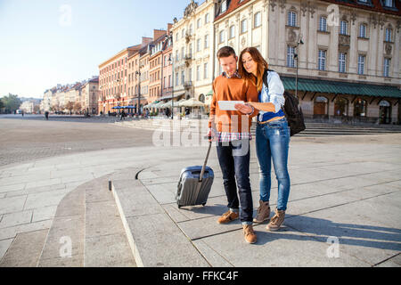 Mid adult couple on a city break using digital tablet Stock Photo
