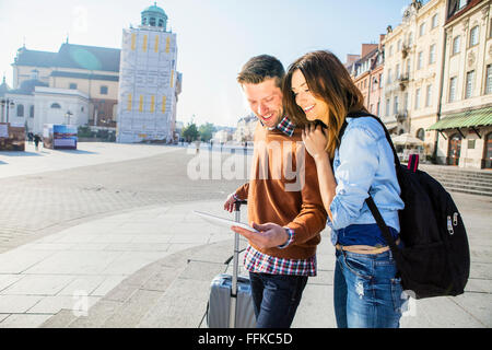 Mid adult couple on a city break using digital tablet Stock Photo