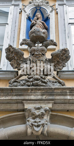Ancient decoration statue closeup on the house facade in Graz, Styria, Austria. Virgin Mary and double eagle. Stock Photo