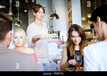 Group of friends celebrating in restaurant Stock Photo
