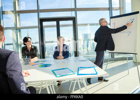 Senior architect giving presentation in business meeting Stock Photo