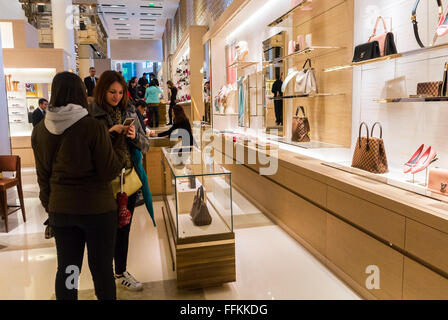 Paris, France, Woman Holiday Shopping, Texting on telephone inside French  Department Store, Galeries Lafayette, Luxury Brand Store Product display;  Louis Vuitton, shopper Using Iphone, haute couture accessories, centre  fashion, clothing store women