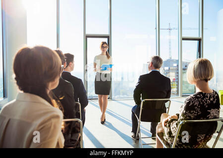 Businesswoman giving presentation in business meeting Stock Photo