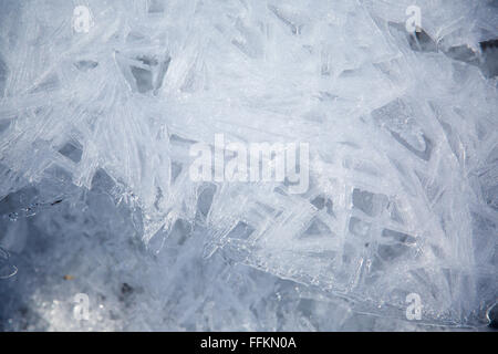 Geometric designs in the ice in a frozen Canadian stream. Stock Photo
