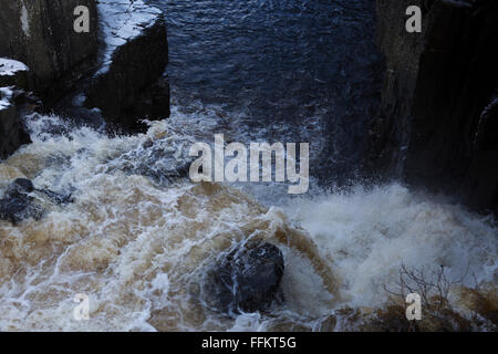 The River Tees tumbles over High Force at Upper Teesdale in County Durham, England. The water runs white. Stock Photo