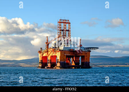 A lone oil rig floats in the Cromarty Firth in the highlands of scotland on a sunny day. Stock Photo