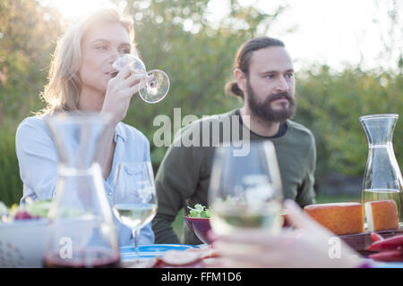 Woman drinking red wine on garden party Stock Photo