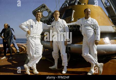 NASA Apollo 14 astronauts Alan B. Shepard Jr. (left), commander, and Edgar D. Mitchell, lunar module pilot, right, and Stuart A. Roosa, command module pilot, center, relax on the Command Module retriever during egress training in the Gulf of Mexico October 24, 1970 in Florida. Stock Photo