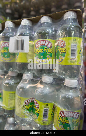 Bottles of Lowes sugar free lemonade soft drink wrapped in cellophane and stacked in a warehouse. Stock Photo