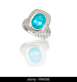 Turquoise blue topaz cushion cut gem stone set in a silver and gold duotone halo setting with diamonds Stock Photo