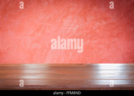 Old empty wooden table top with red wall background, stock photo Stock Photo